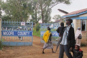 People walk past the gates at the Migori County Hospital.